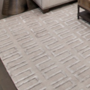 Geometric pattern rug in a monochromatic living room design